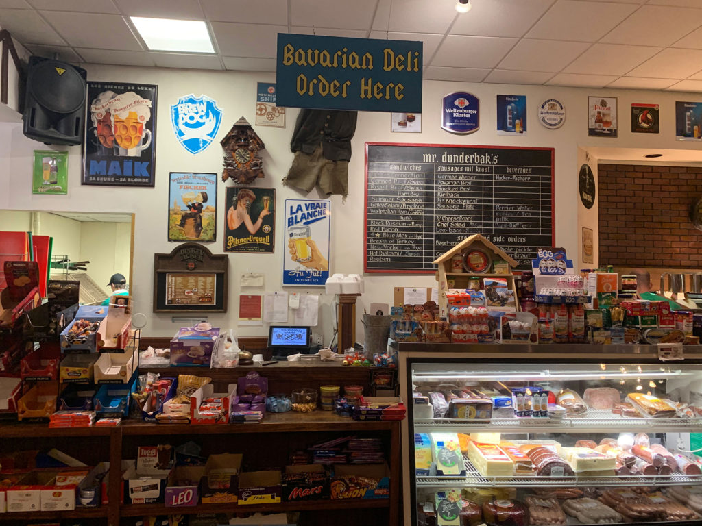 The deli at Mr. Dunderbak's. Shelves of European candies and a deli case with meats and cheese.