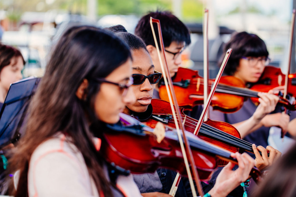 Young students play violin in the Tampa Metro Youth Orchestra