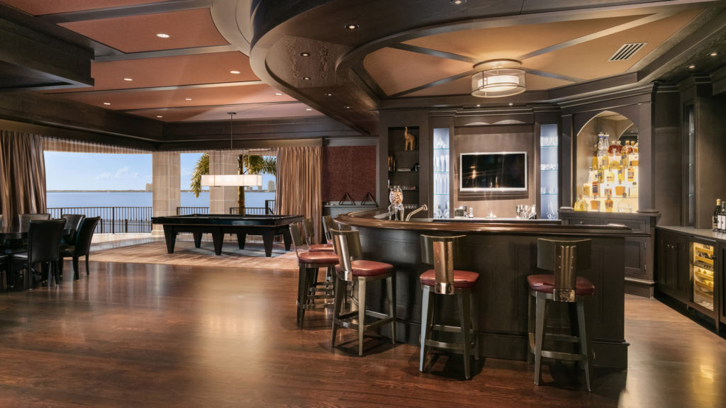A private bar and pool table in a wood accented room in derek jeter's home