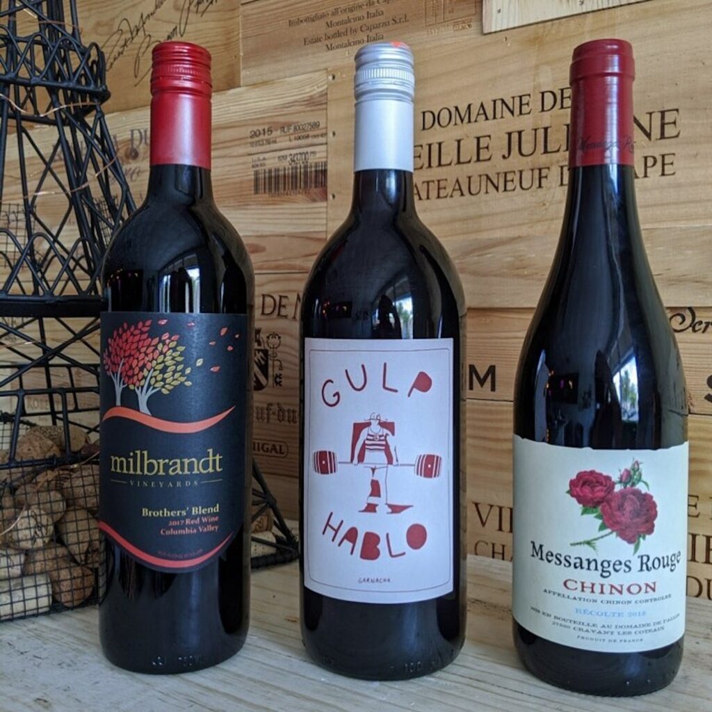 three different bottles of red wine. 