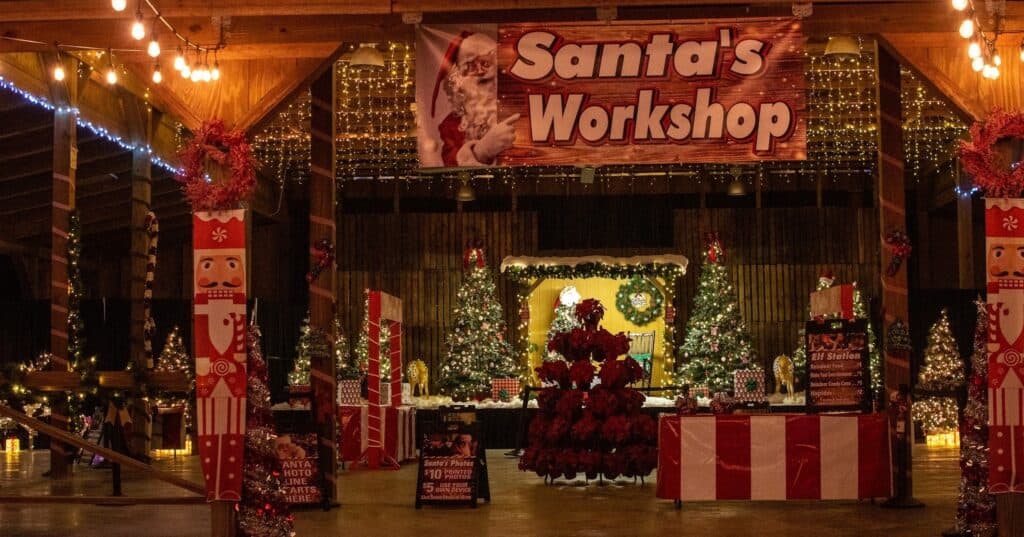 Santa's workshop is filled with large Nutcrackers, Christmas trees, and wrapped presents. 