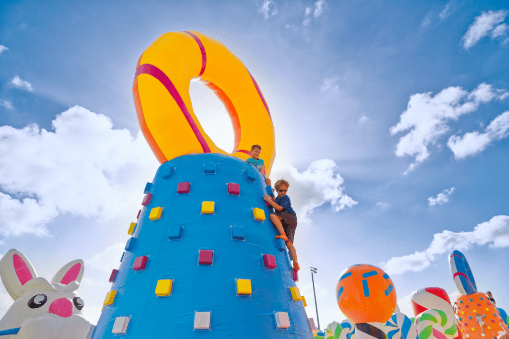 A talle blue inflatable climbing wall. 
