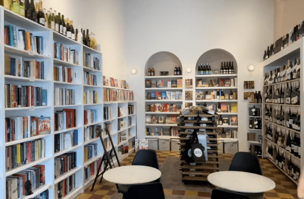 A bookstore with wine shelves 