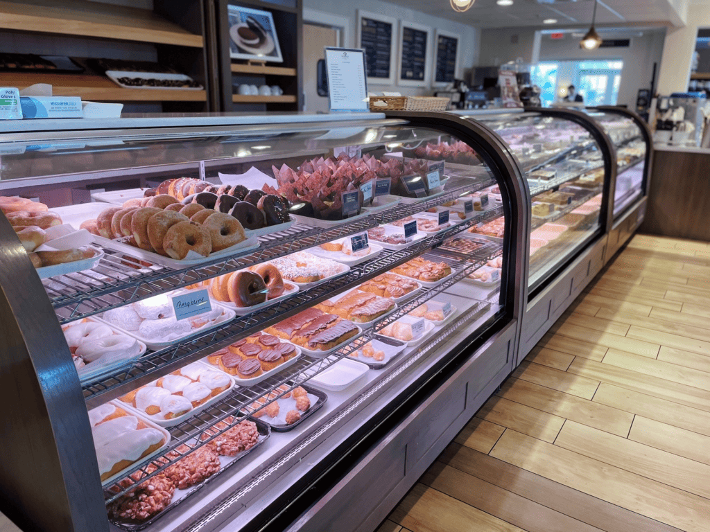 bakery at an amish restaurant. Doughnuts, cookies, slices of pie visible on the shelves. 