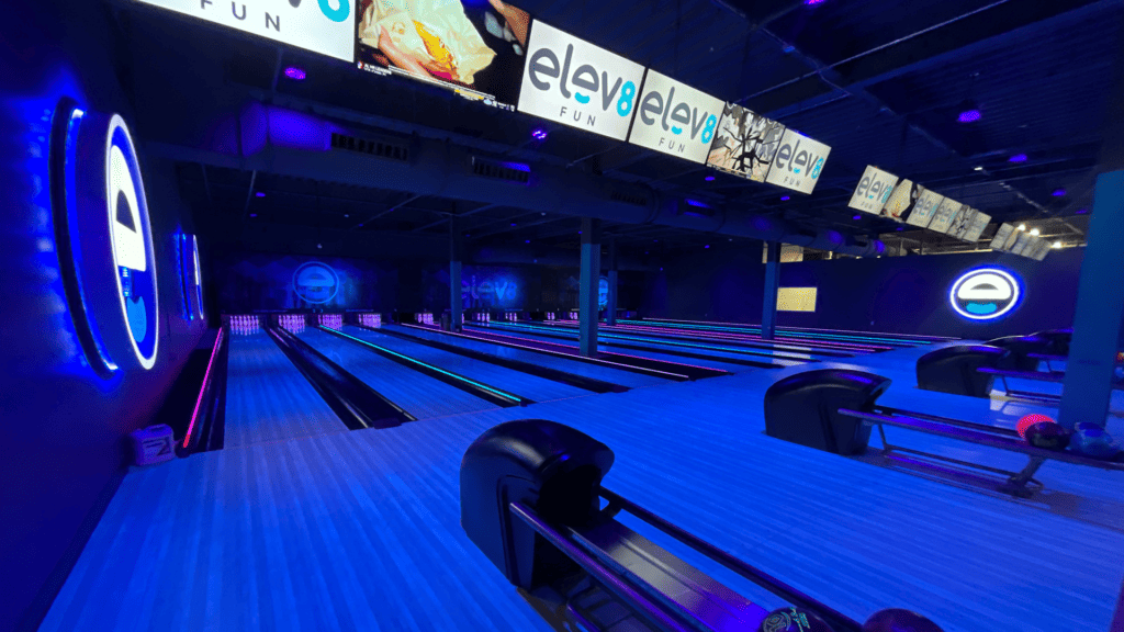 a bowling alley under blue lights